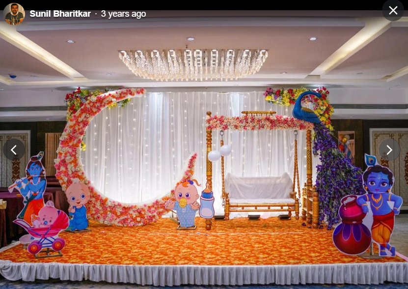 Krishna themed cradle ceremony with peacock and floral arch