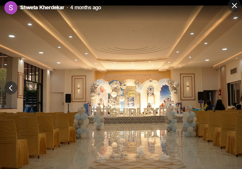 Full hall view of penguin theme birthday setup with marquee name