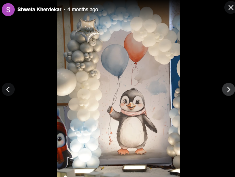 Hand painted penguin backdrop with silver balloon garland